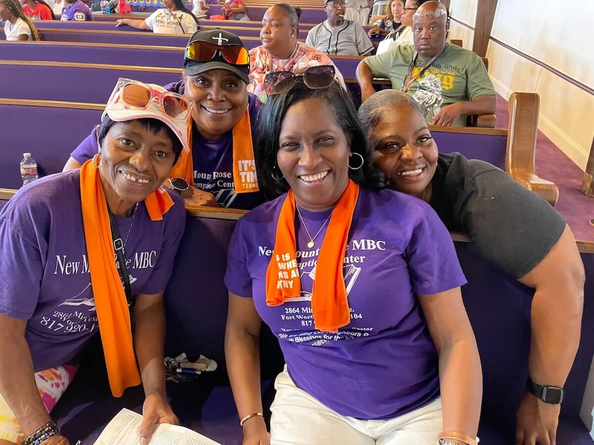 Five women of color posing for a photo