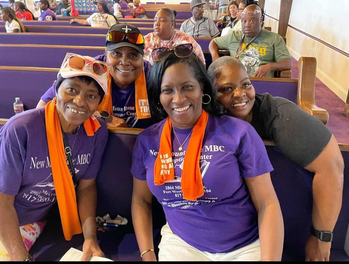 Four women smiling for a photo